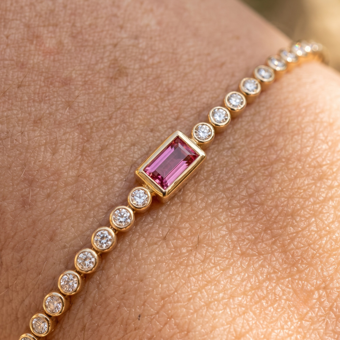 Kiashaa Jewellery 1.75 CTW diamond tennis bracelet with pink baguette center stone in yellow gold.