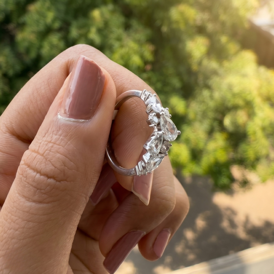 Handcrafted lab-grown diamond ring with pear and round brilliant stones.