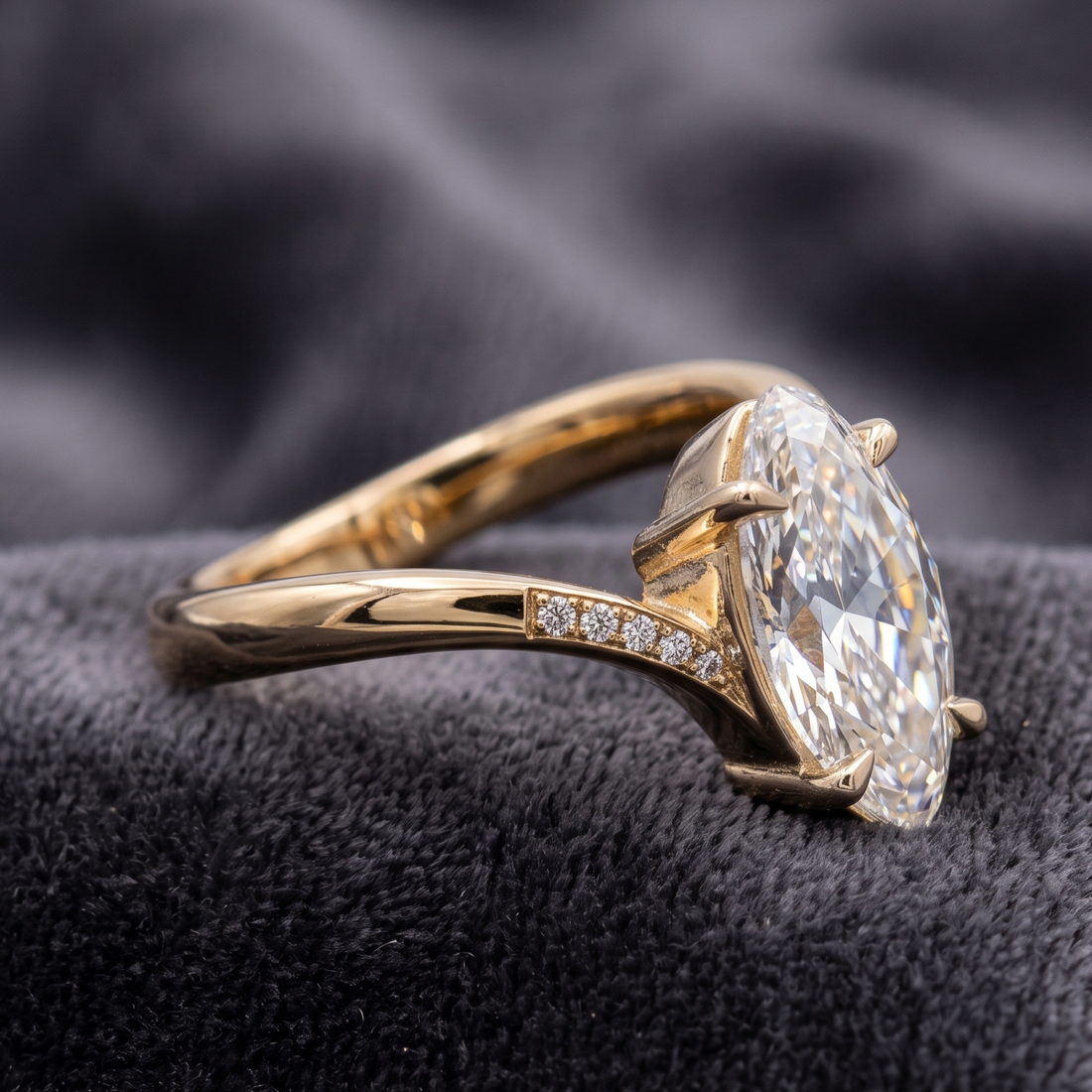 Oval diamond proposal ring with sculptural V-shaped gold band