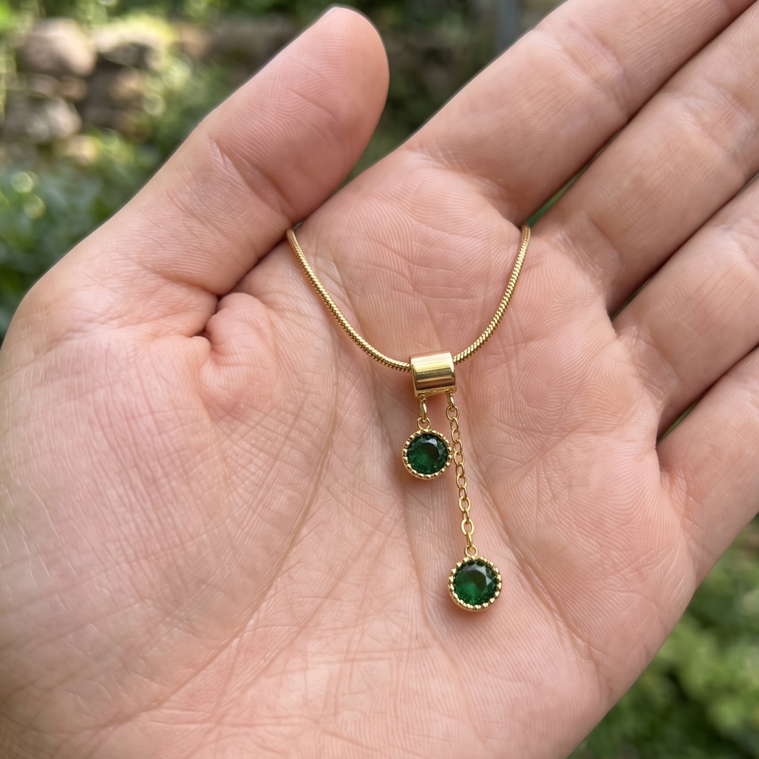  1.50 CTW green round gemstone drop necklace in polished yellow gold.