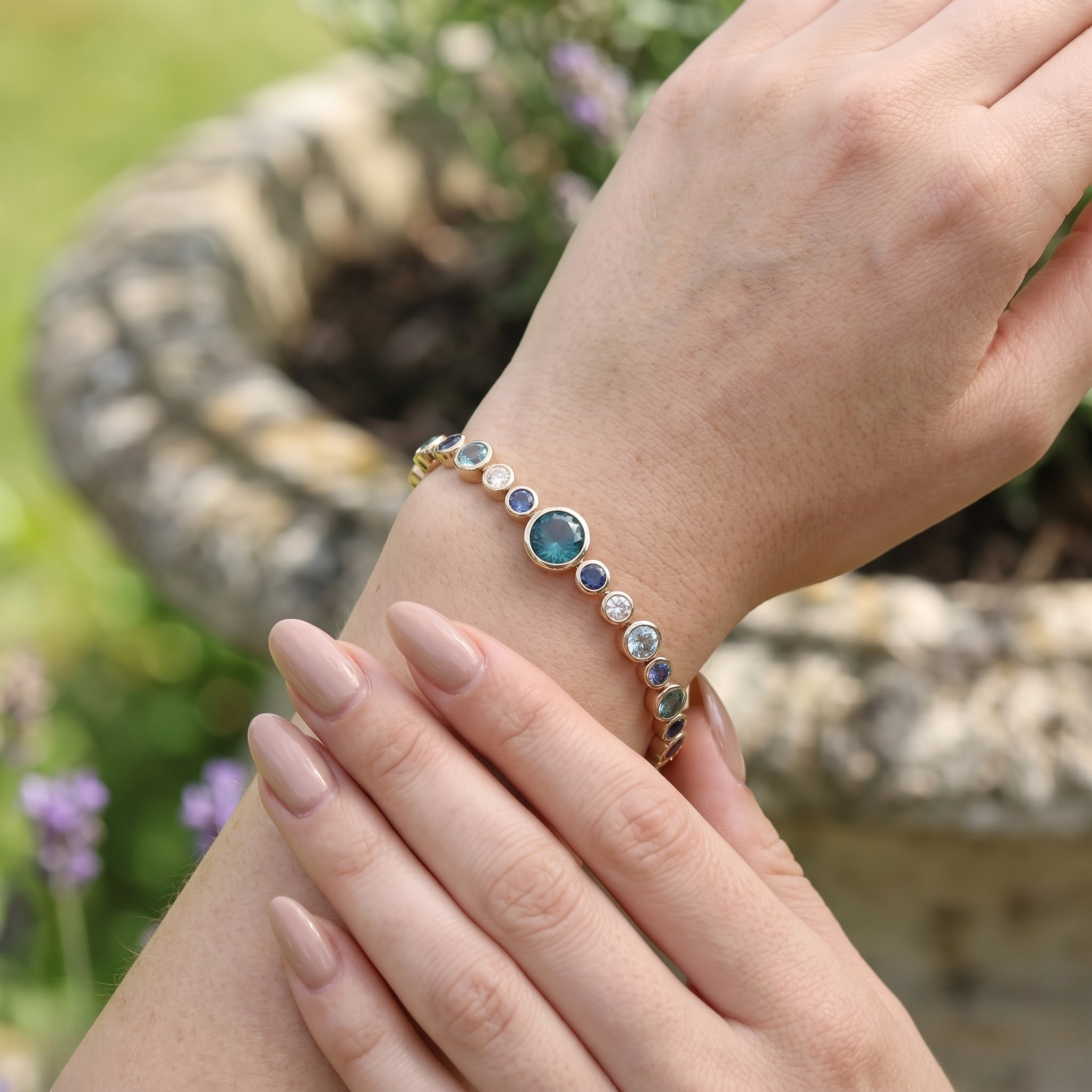 Rainbow bracelet featuring a continuous row of vibrant round gemstones.