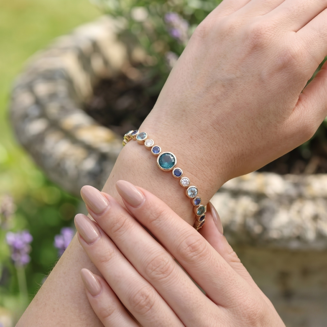 Rainbow bracelet featuring a continuous row of vibrant round gemstones.