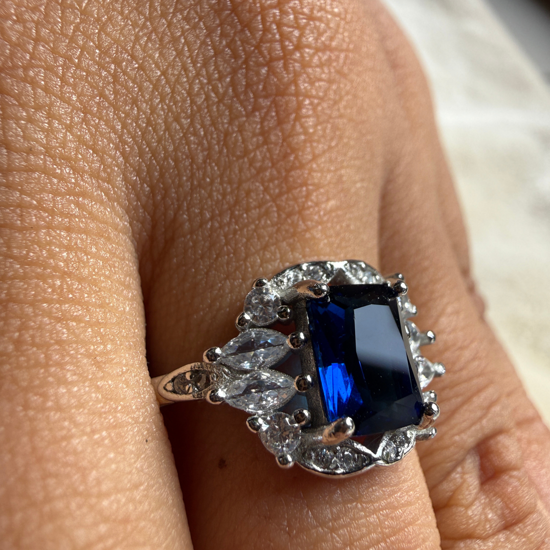 Blue emerald gemstone and lab-grown diamond halo ring by Kiashaa Jewellery.