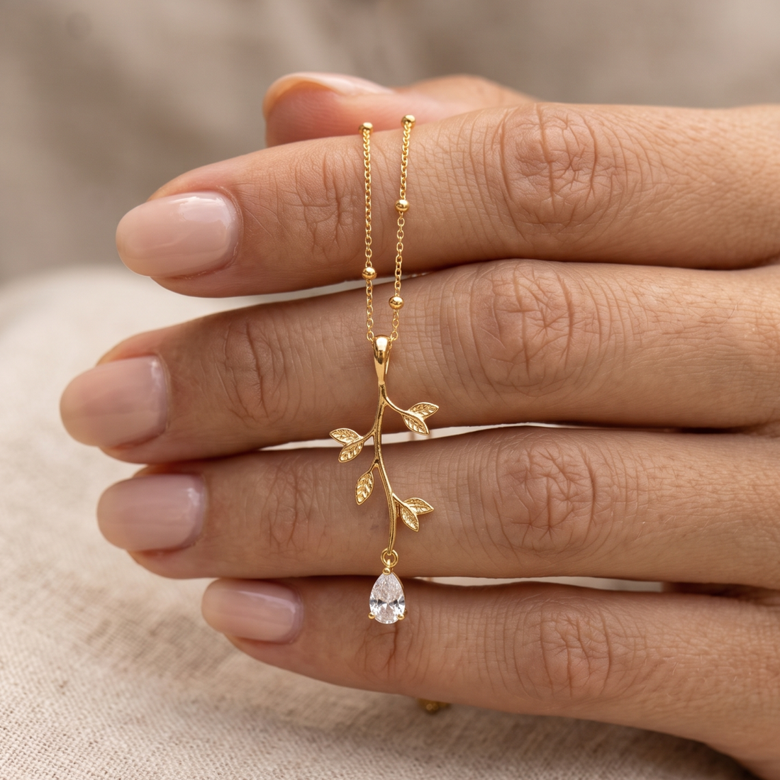 Kiashaa Jewellery 0.39 CT pear diamond leaf pendant necklace in polished yellow gold.