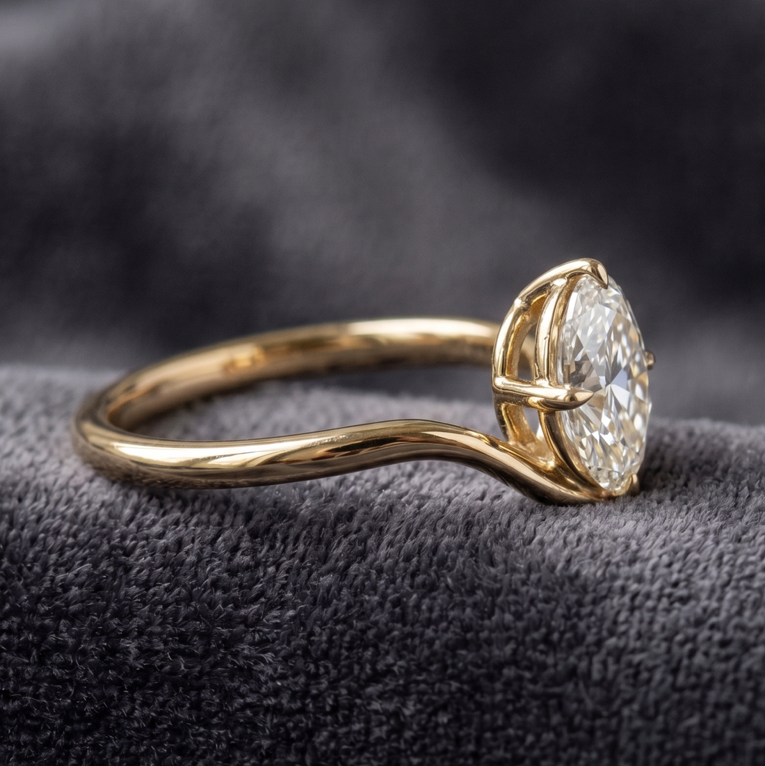 Large oval diamond solitaire ring with sculptural yellow gold band
