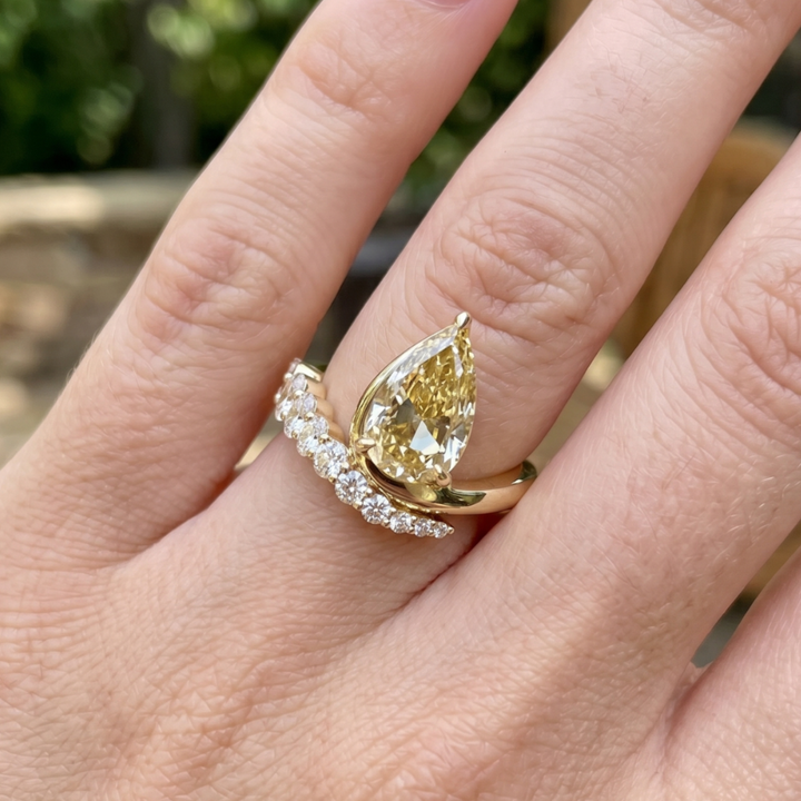 Aurelia 4.50 CTW pear diamond bypass ring by Kiashaa Jewellery featuring a 3 CT pear center diamond in polished yellow gold.
