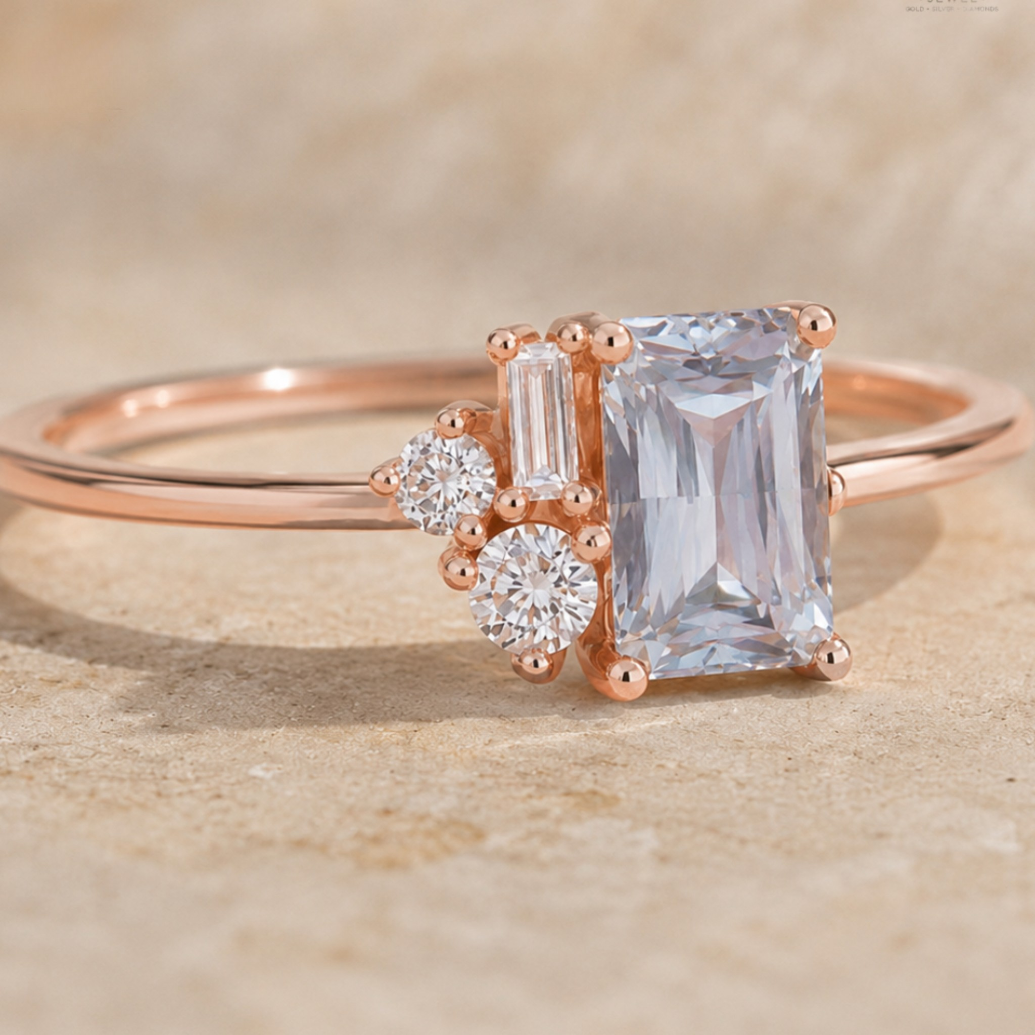 Rose gold ring featuring a large emerald-cut clear gemstone, a baguette-cut clear gemstone, and two round clear gemstones, set on a warm beige stone-textured background.