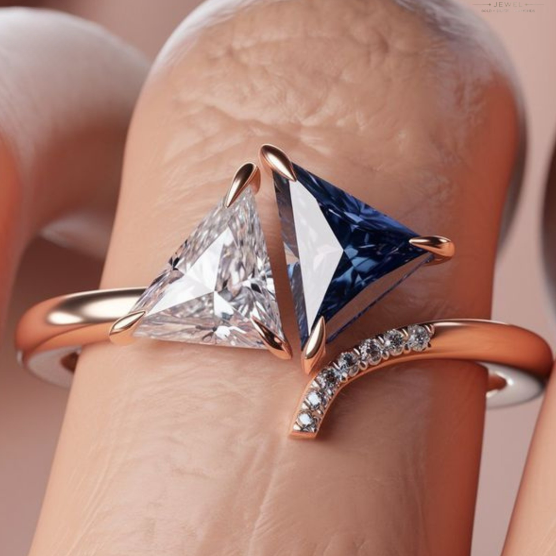 A close-up of a ring worn on a finger, featuring two triangular gemstones in rose gold settings: one clear and one deep blue, with a curved rose gold band accented by small clear stones.