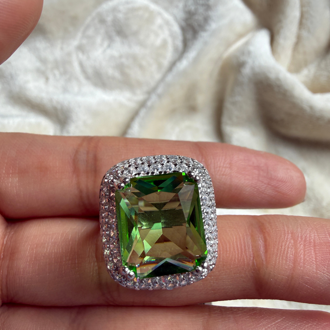 Green emerald-cut gemstone and lab-grown diamond double halo ring by Kiashaa Jewellery.