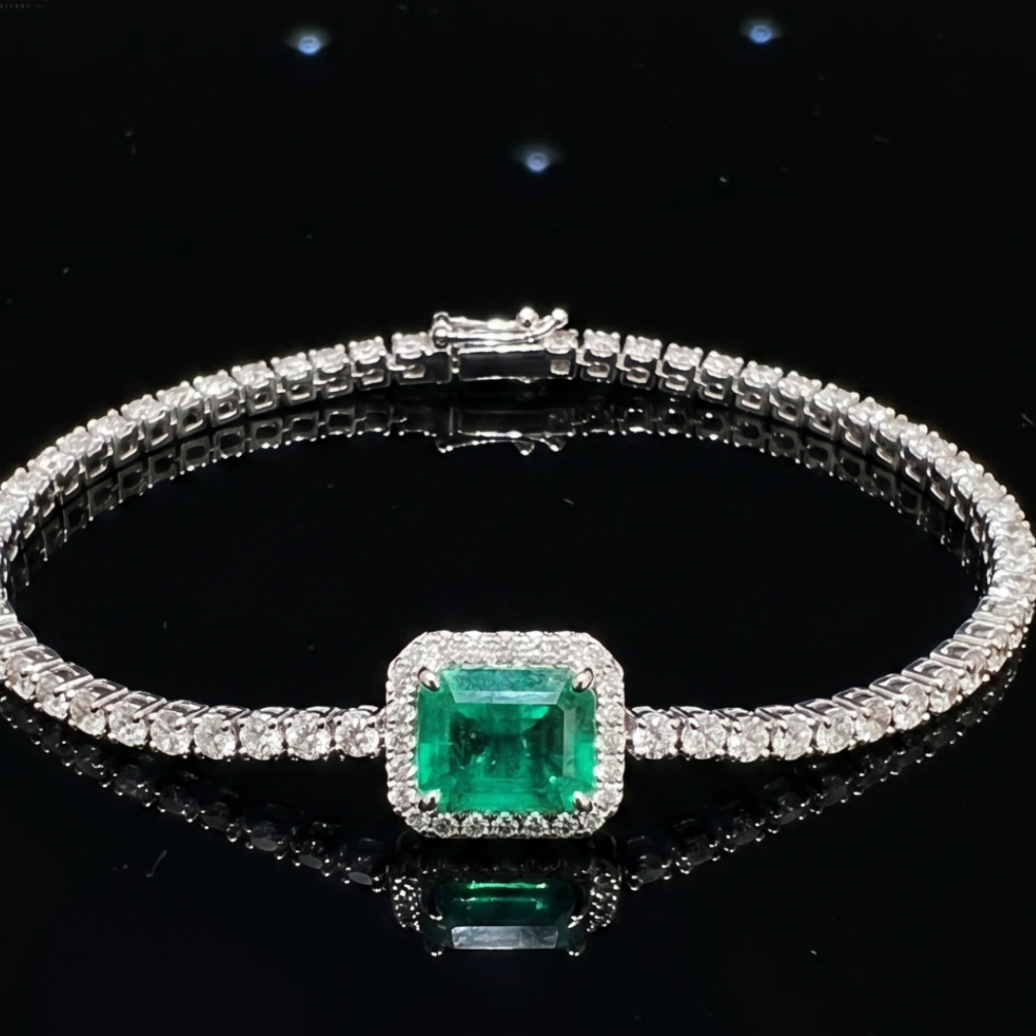 A silver-toned tennis bracelet featuring a square-cut green emerald gemstone in a halo setting, with a row of small clear stones along the band, displayed on a reflective black surface.
