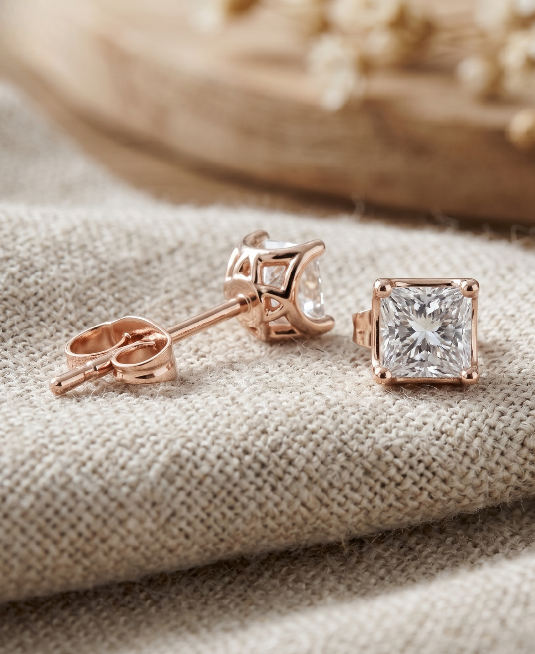 Elegant princess cut diamond stud earrings crafted in premium rose gold.