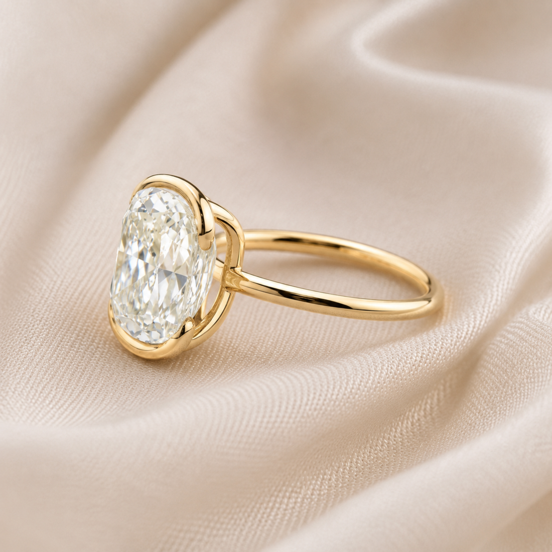 Large oval diamond engagement ring with minimalist yellow gold band