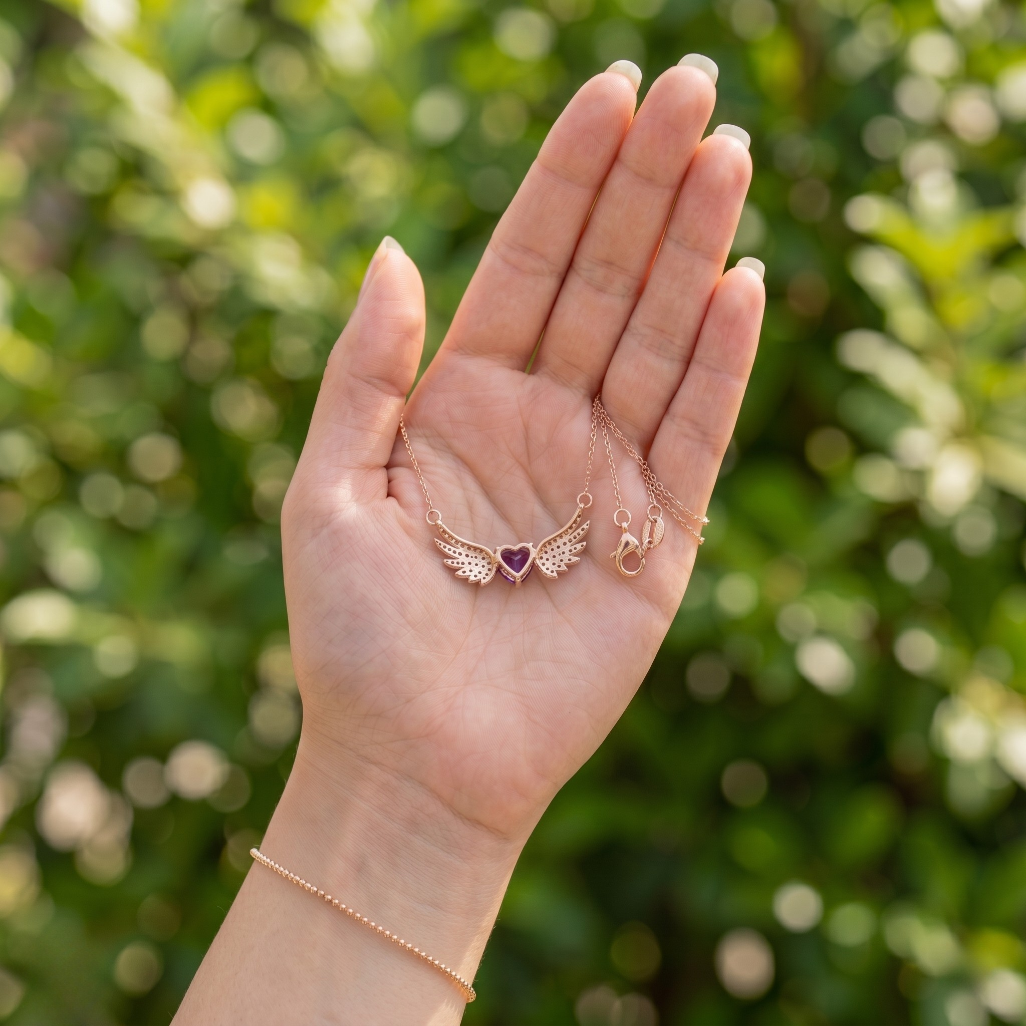 Purple heart gemstone angel wing pendant necklace in rose gold by Kiashaa Jewellery.