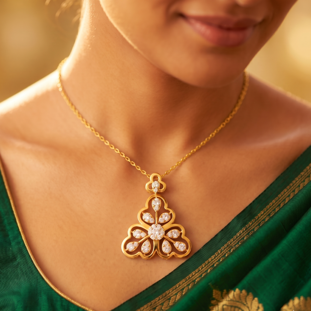 A close-up lifestyle shot of a woman wearing a gold pendant necklace with a diamond-encrusted floral motif, paired with a green saree.