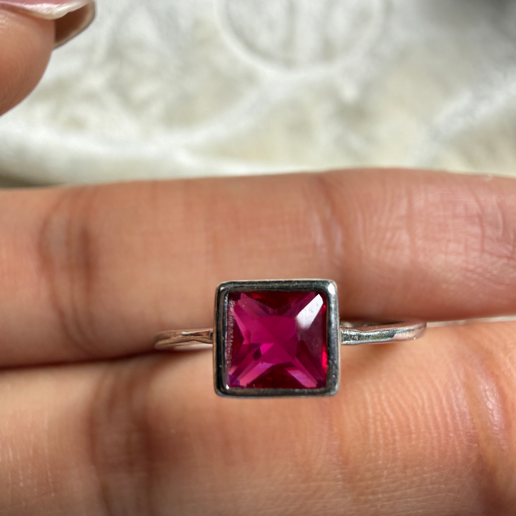 Red princess-cut gemstone solitaire ring in white gold by Kiashaa Jewellery.