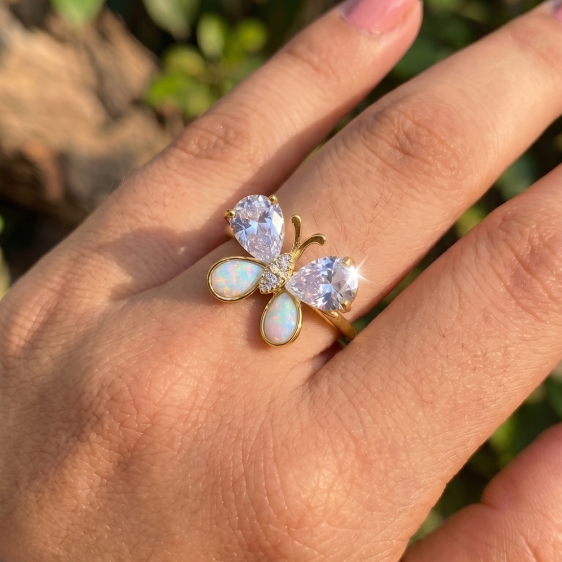 Nature-inspired butterfly ring featuring pear-shaped lab-grown diamonds and opal gemstones.
