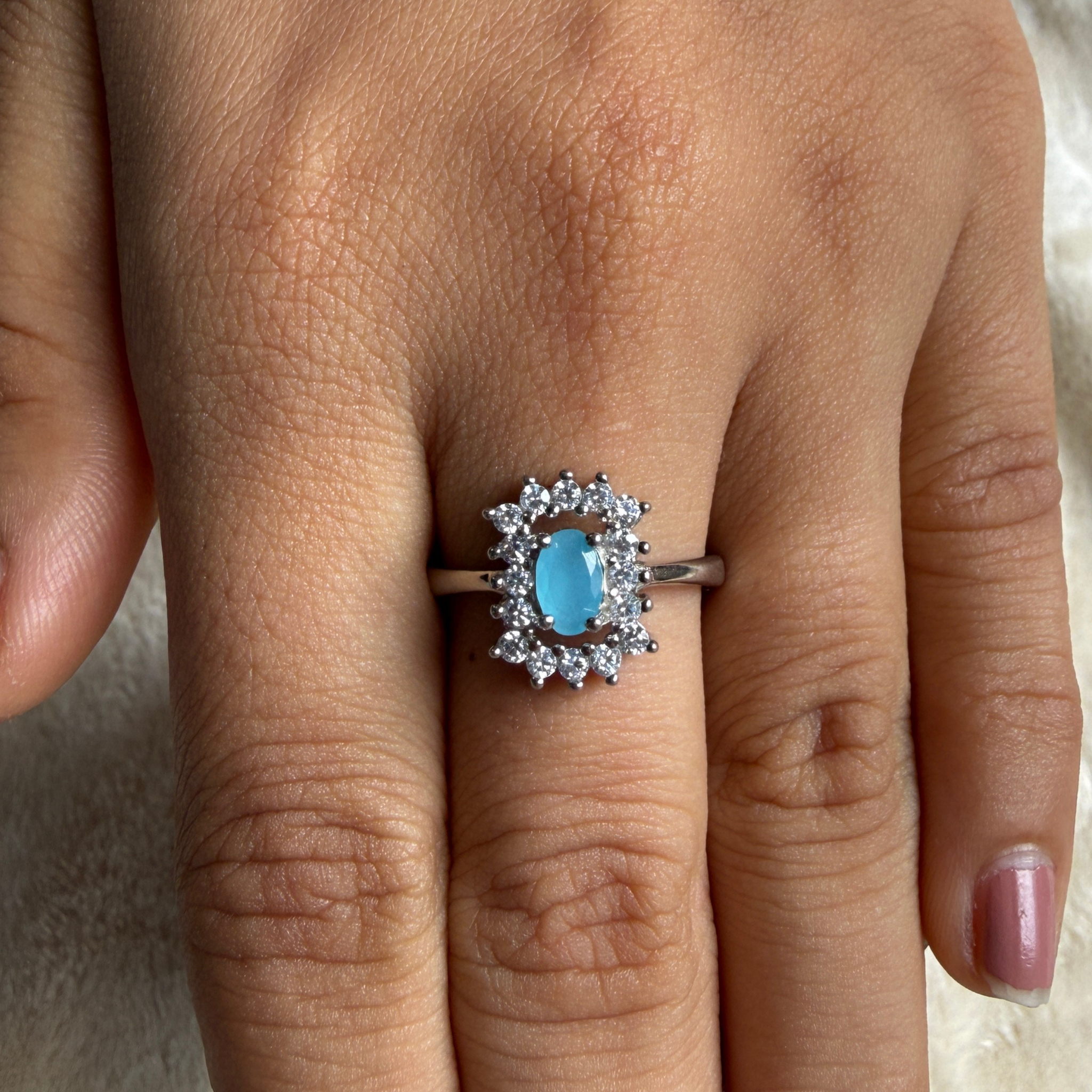 Sky blue oval gemstone and lab-grown diamond halo ring by Kiashaa Jewellery.