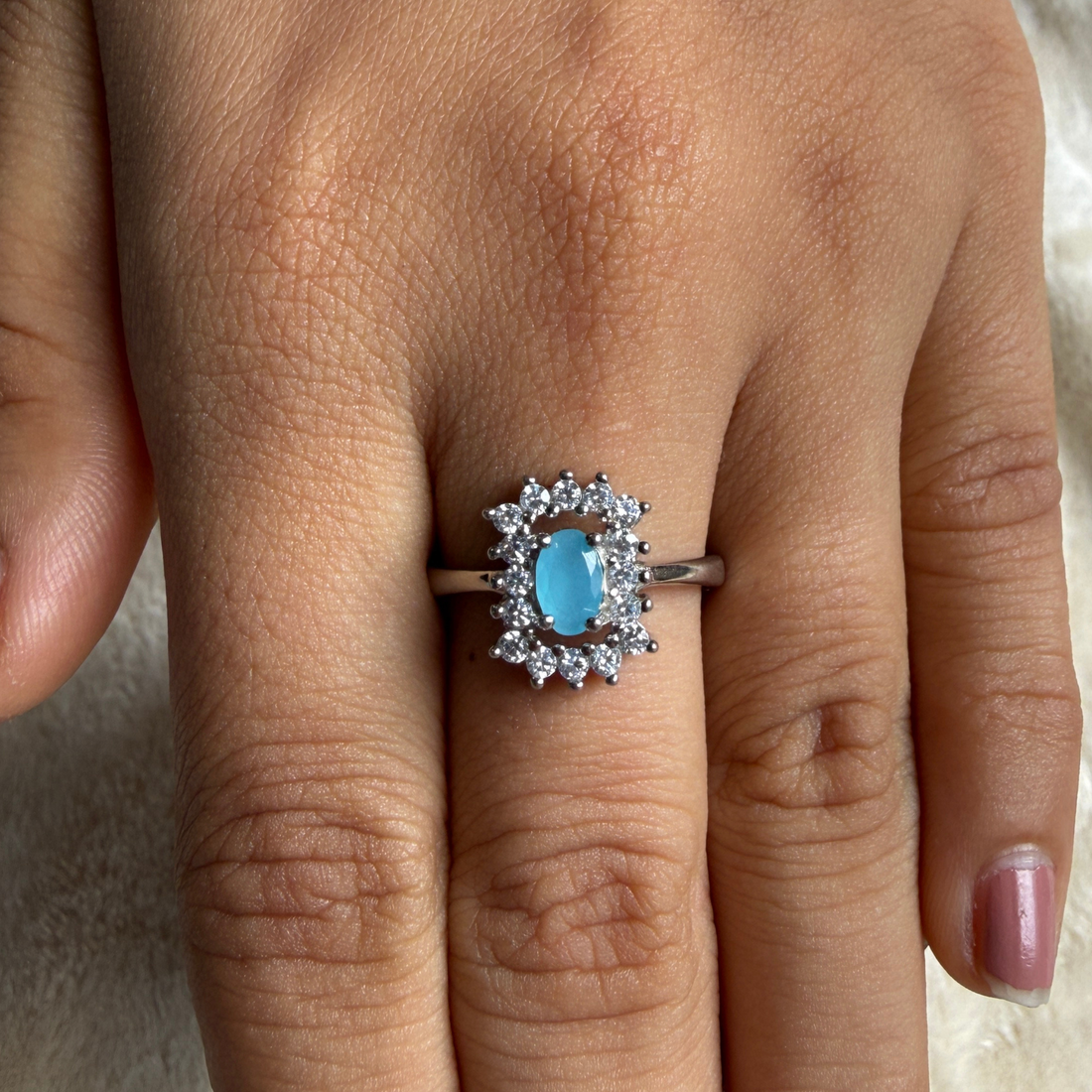 Sky blue oval gemstone and lab-grown diamond halo ring by Kiashaa Jewellery.