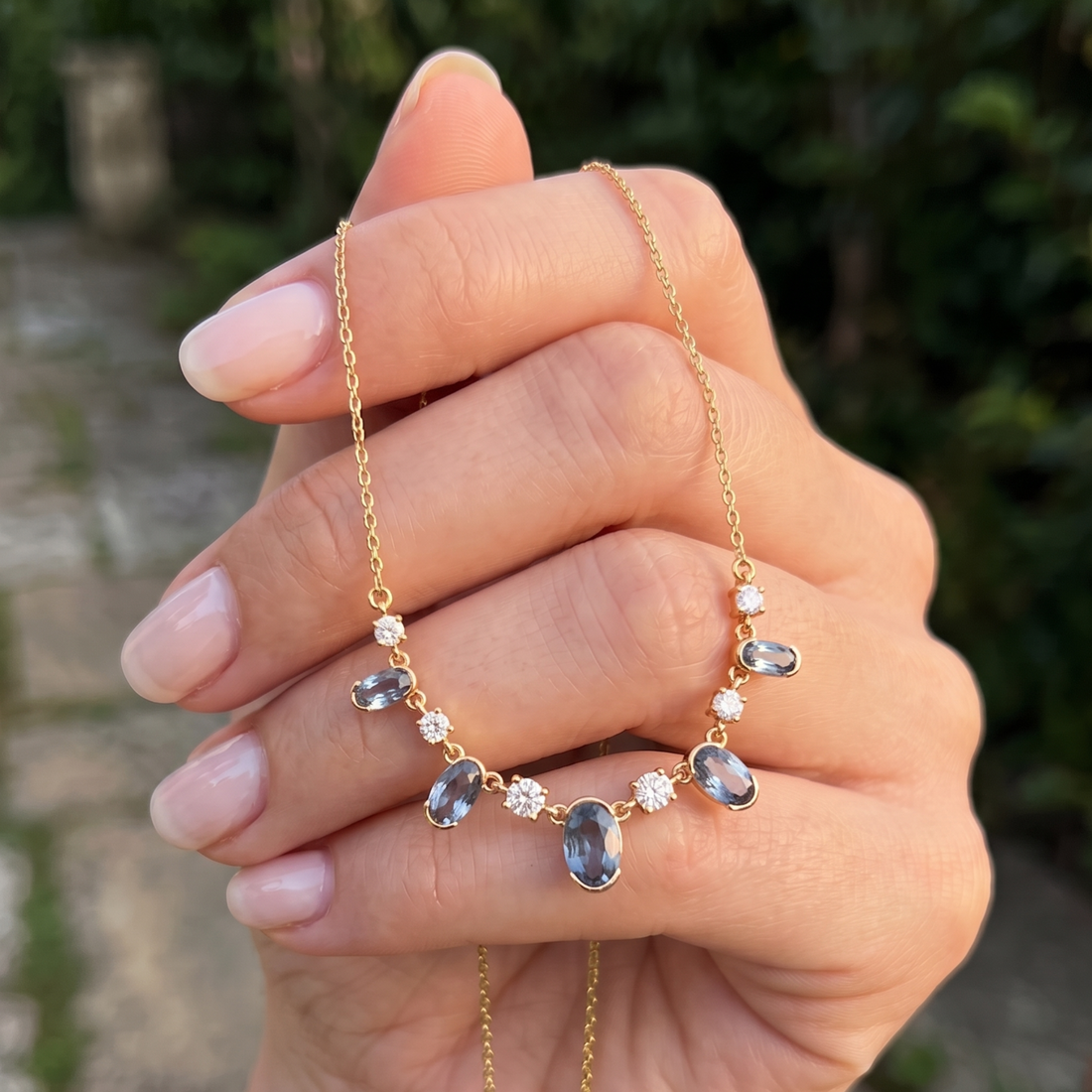 4.20 CTW oval and round diamond station necklace in polished yellow gold.
