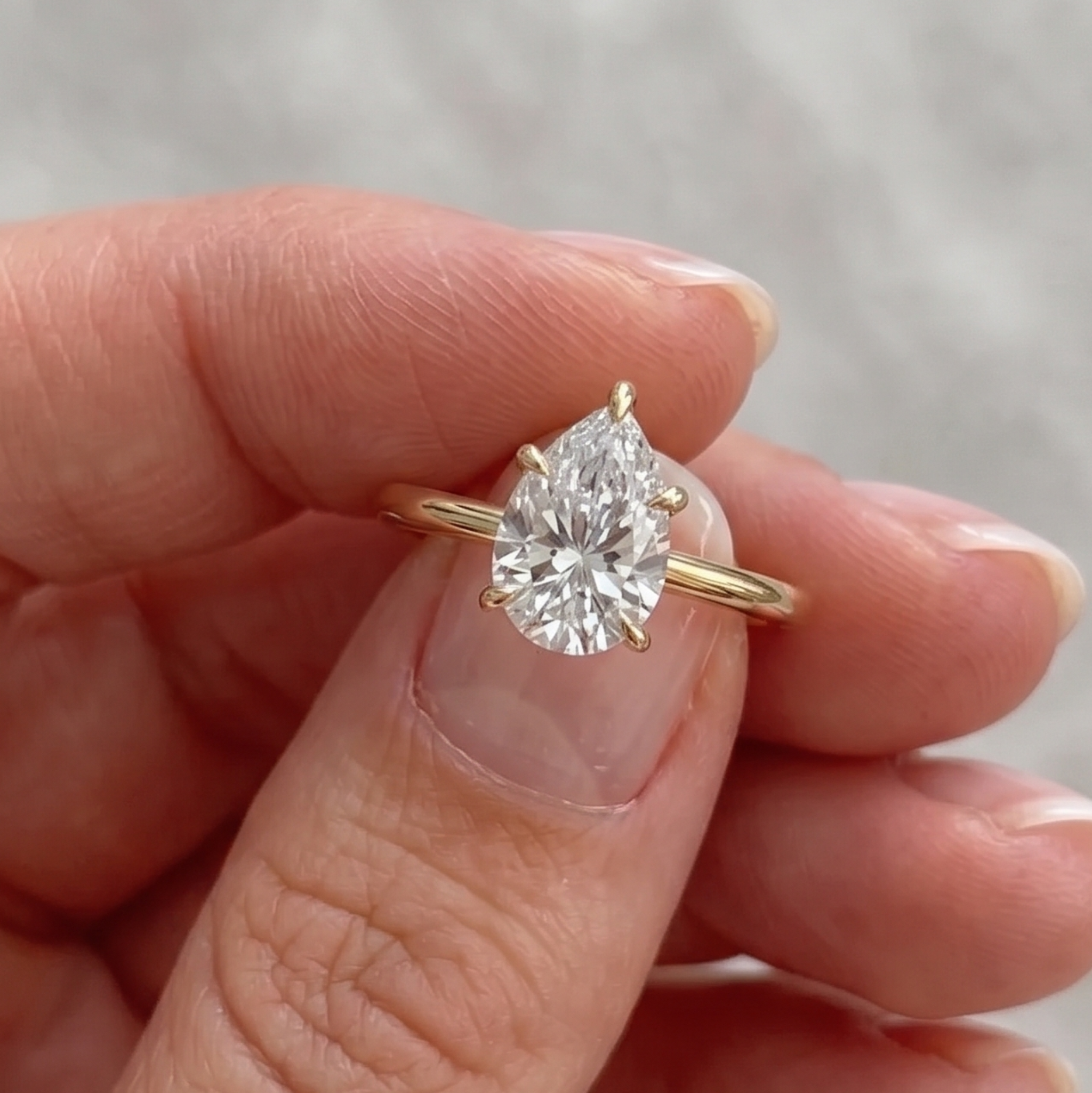 Yellow gold pear diamond solitaire proposal ring