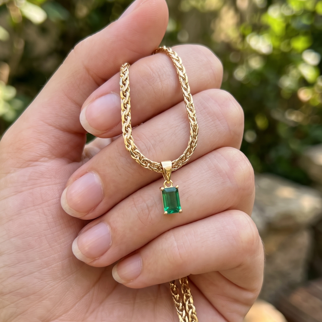 1.98 CT green emerald-cut pendant necklace in polished yellow gold.