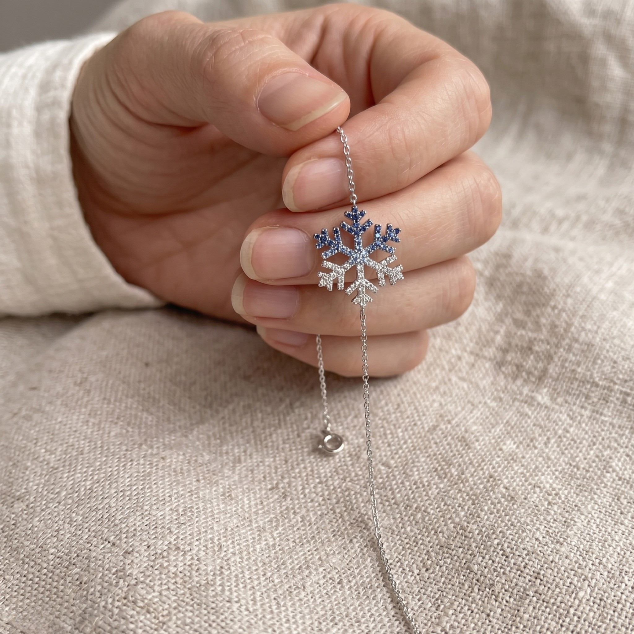 Blue gemstone and lab-grown diamond snowflake bracelet by Kiashaa Jewellery.
