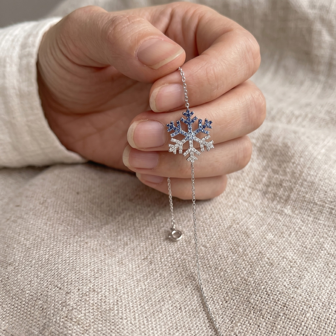 Blue gemstone and lab-grown diamond snowflake bracelet by Kiashaa Jewellery.