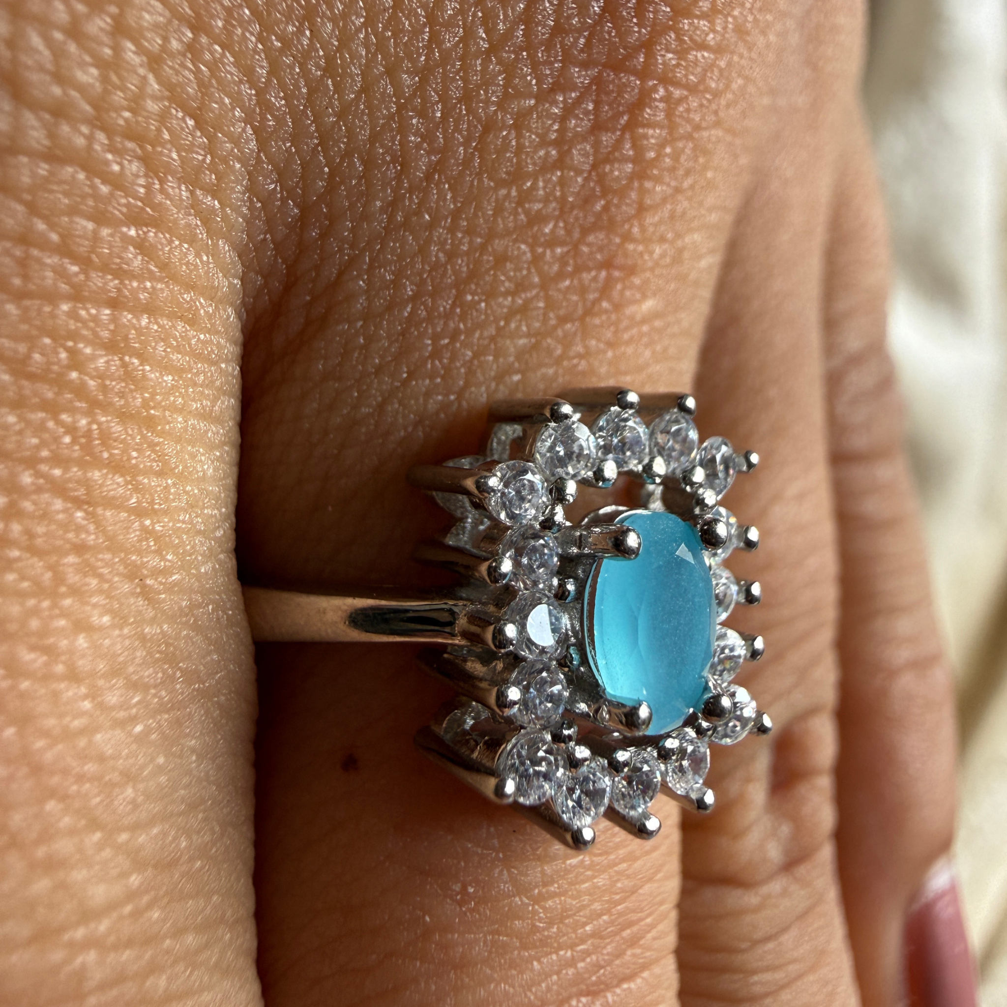 Sky blue oval gemstone and lab-grown diamond halo ring by Kiashaa Jewellery.