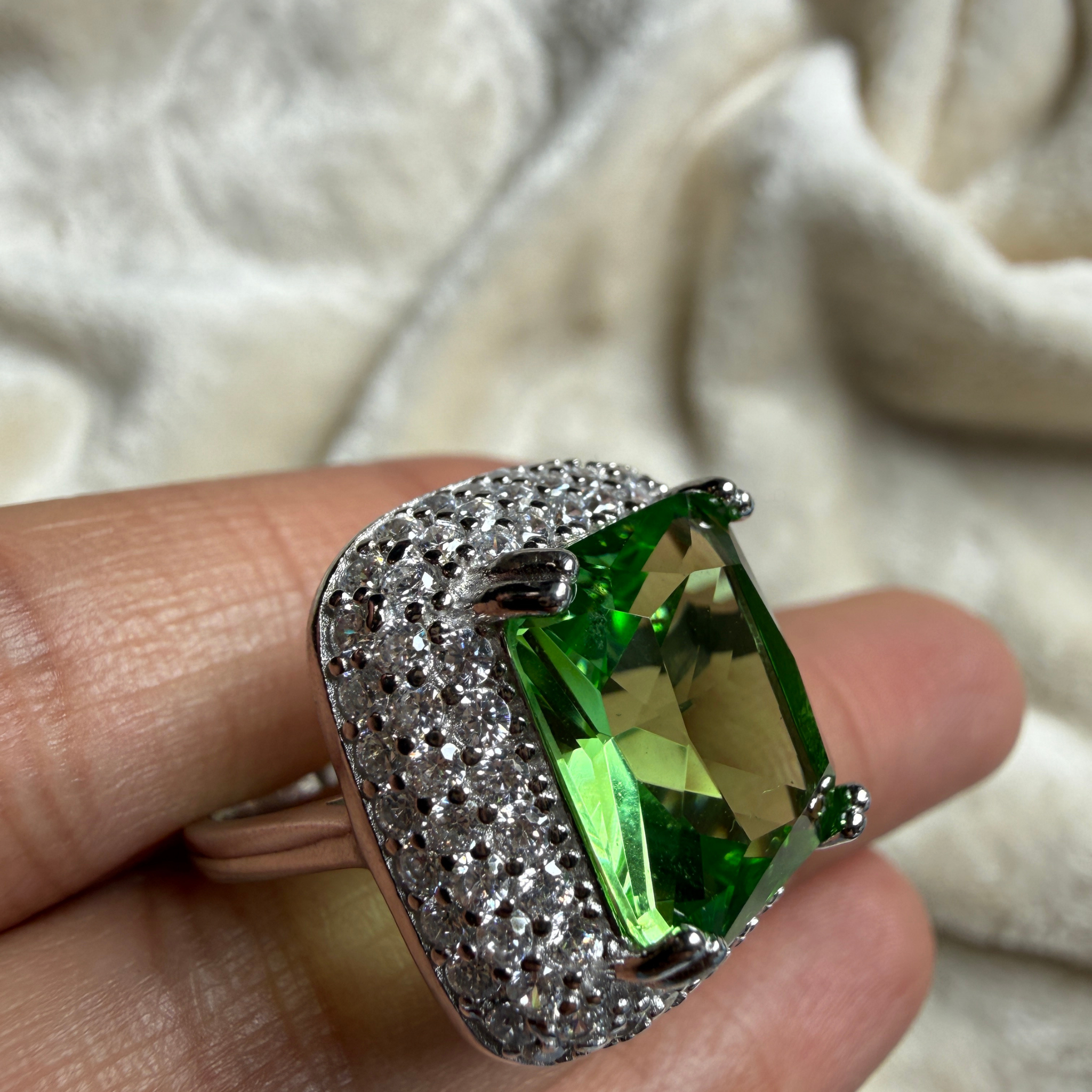 Green emerald-cut gemstone and lab-grown diamond double halo ring by Kiashaa Jewellery.