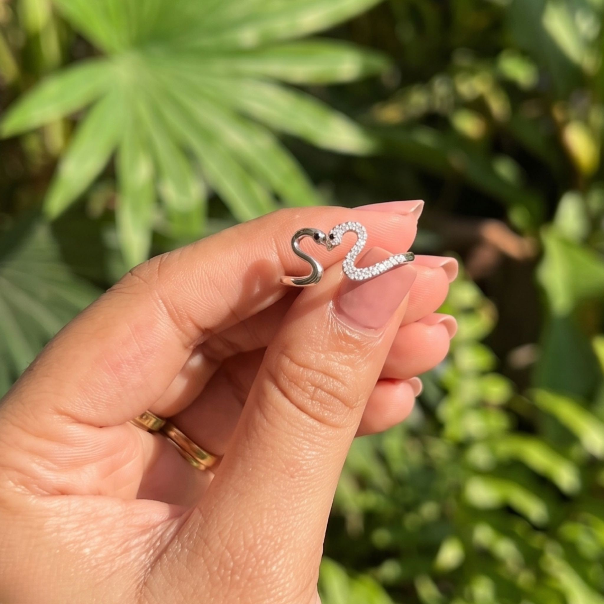 Romantic open ring featuring two swans forming a heart-shaped design.