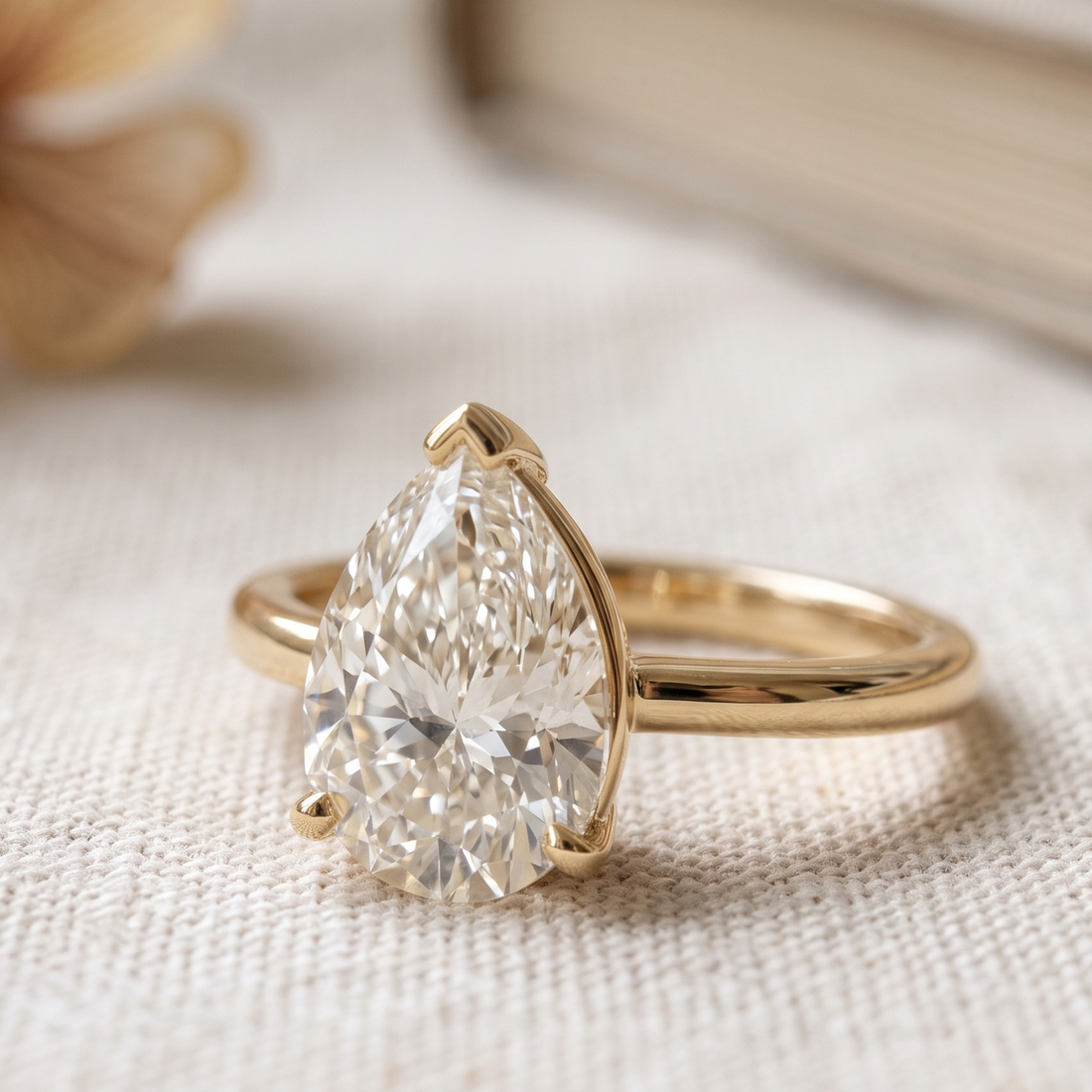 Kiashaa Jewellery 0.76 CT pear solitaire diamond ring in polished yellow gold.