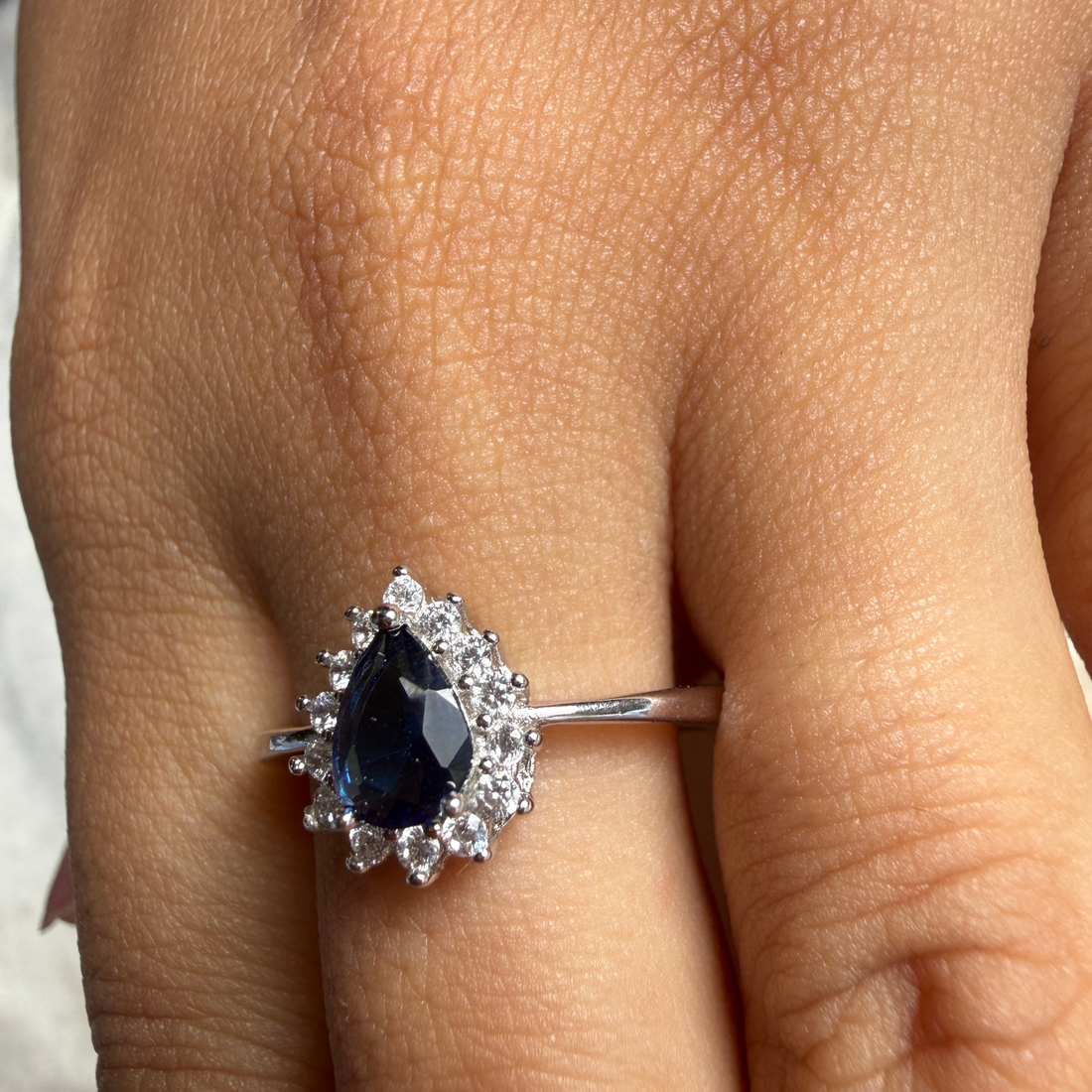Blue pear gemstone and lab-grown diamond halo ring by Kiashaa Jewellery.