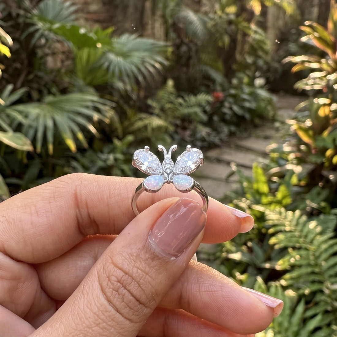 Nature-inspired butterfly ring featuring pear-shaped lab-grown diamonds and opal gemstones.