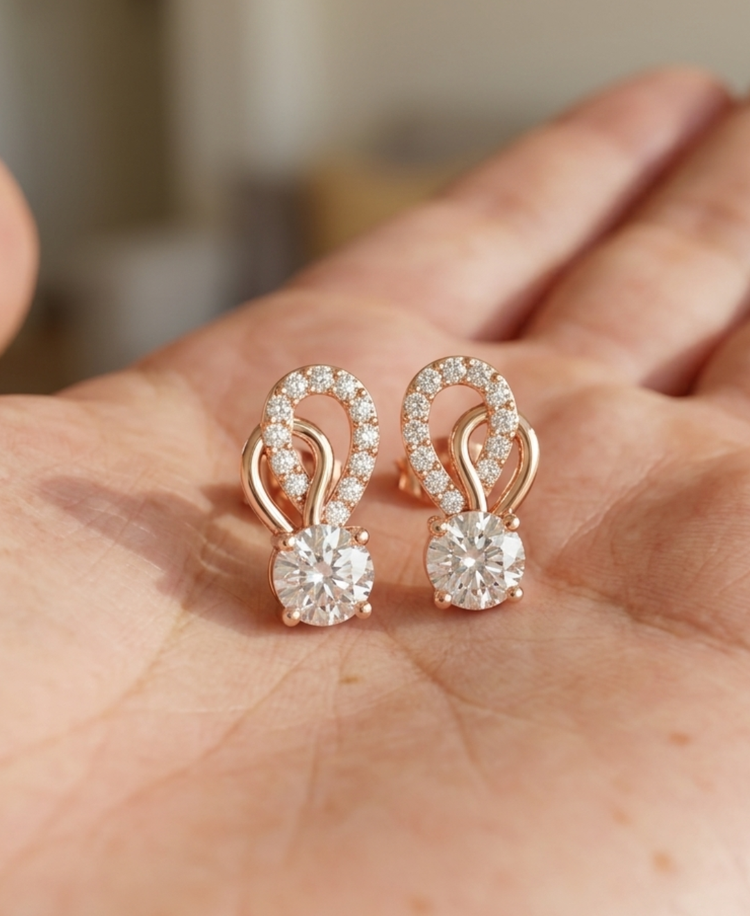 Front view of 1.00 CTW diamond loop earrings displayed as a matching rose gold pair.