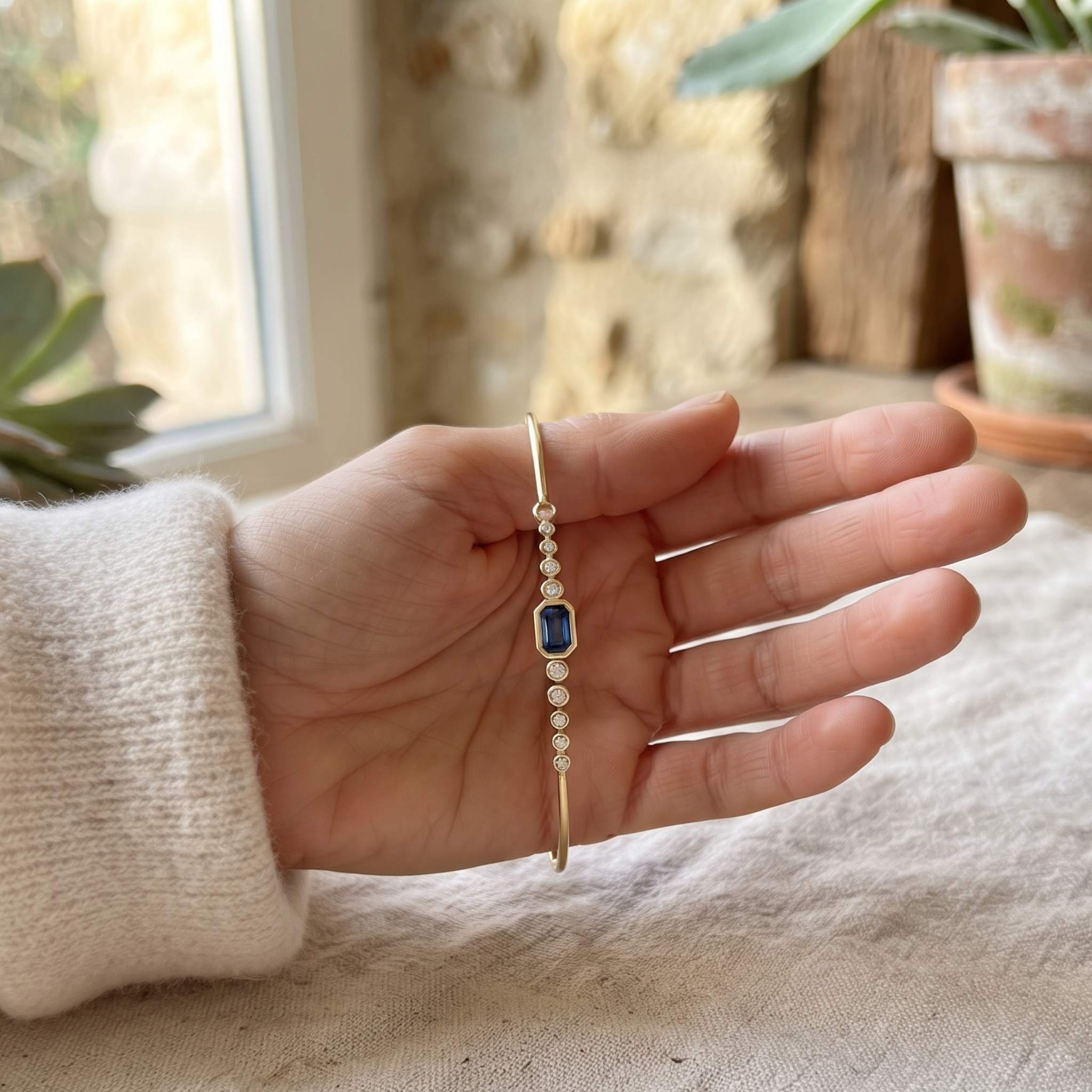Kiashaa Jewellery 1.582 CTW blue emerald and round diamond bangle in polished yellow gold.