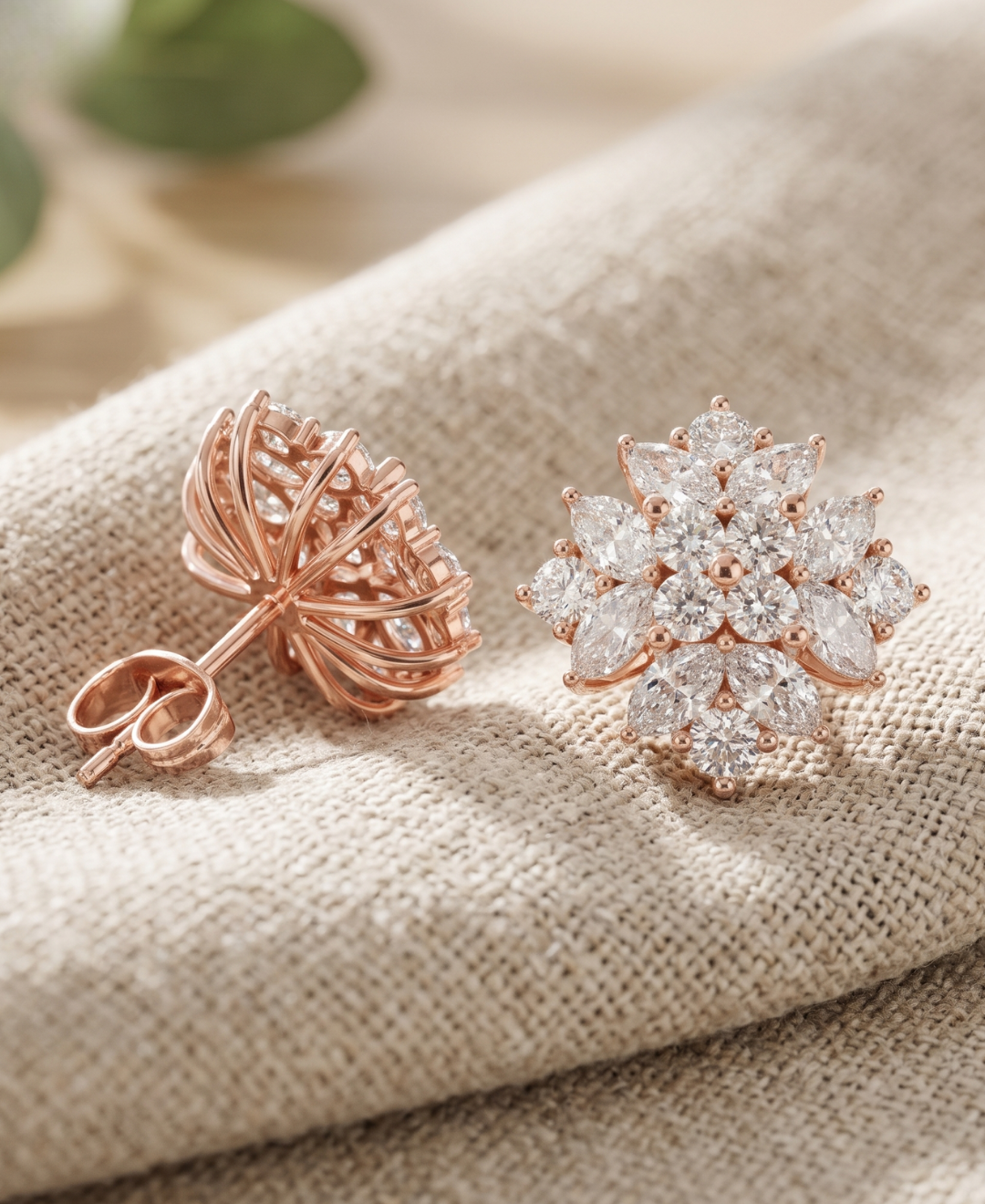 Matching pair of 2.600 CTW flower diamond earrings displayed on soft neutral fabric in natural light.