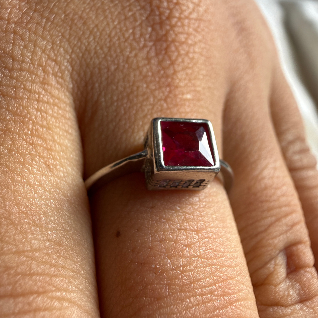 Red princess-cut gemstone solitaire ring in white gold by Kiashaa Jewellery.