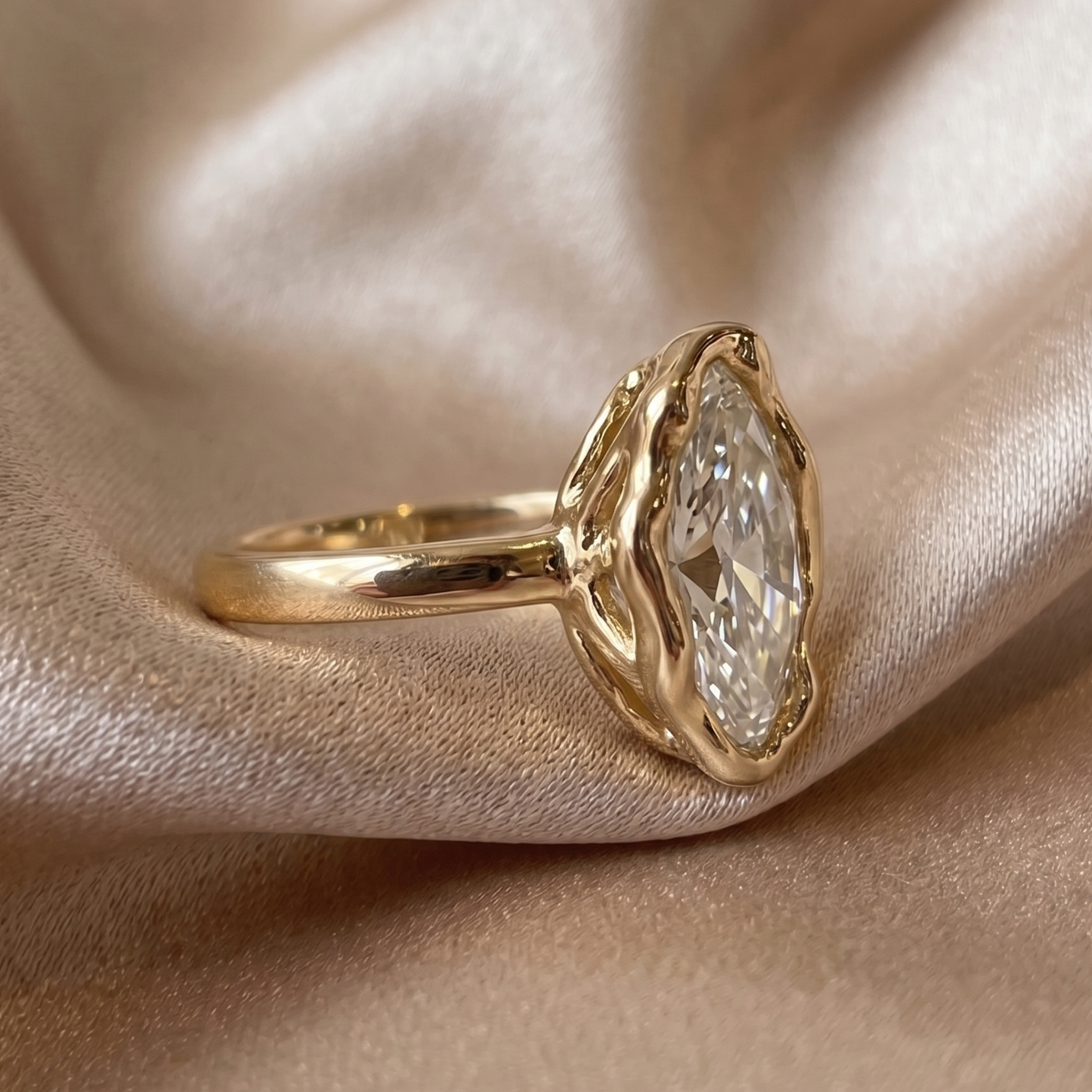 Yellow gold marquise engagement ring with organic freeform bezel setting