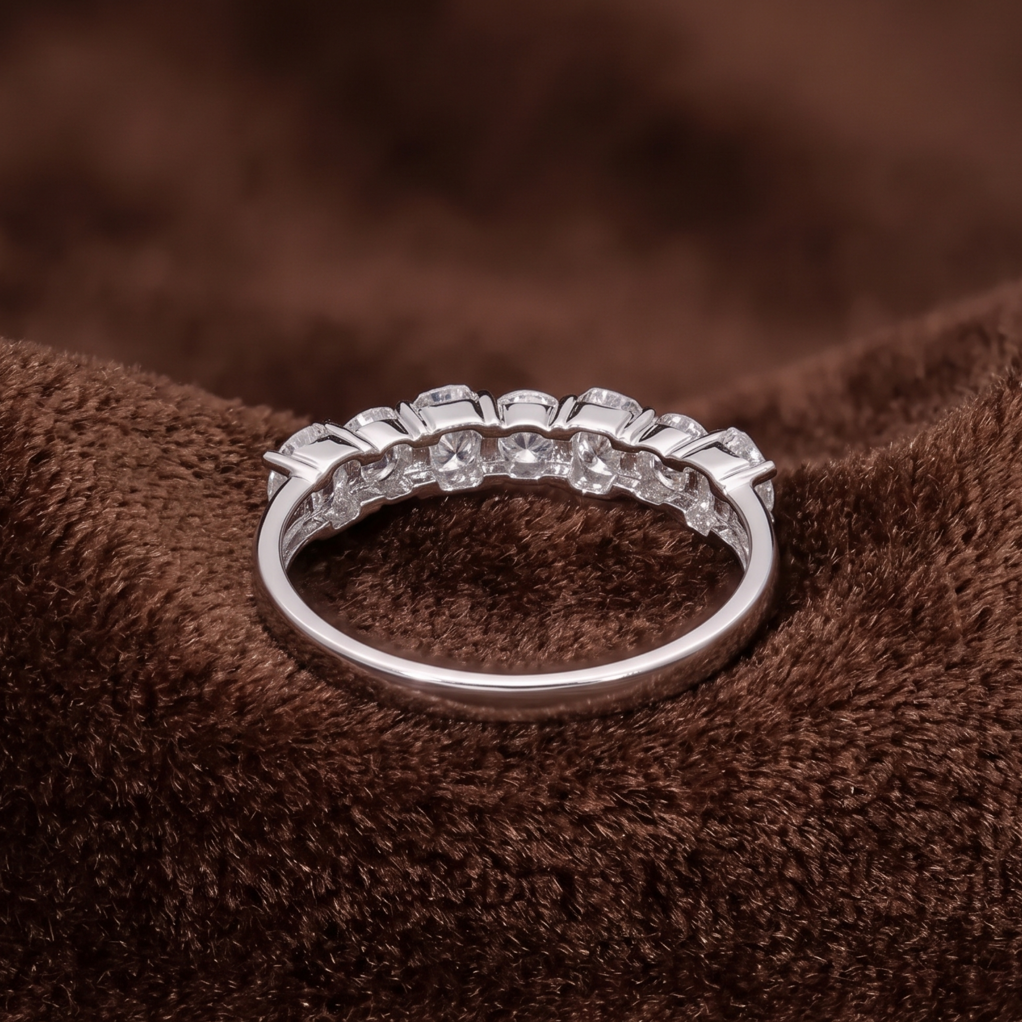 Alternating emerald and round brilliant diamond half eternity band