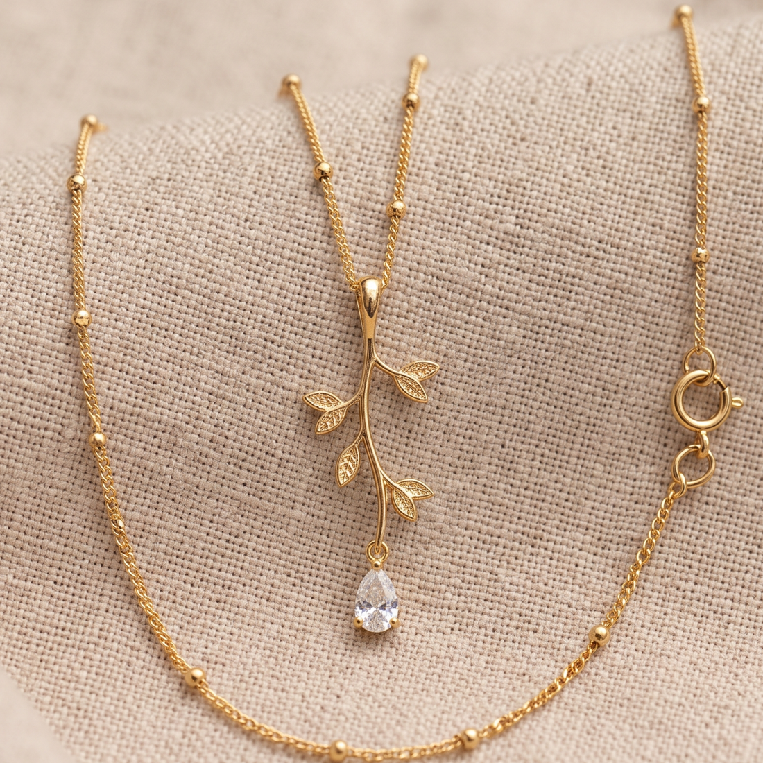 Kiashaa Jewellery 0.39 CT pear diamond leaf pendant necklace in polished yellow gold.