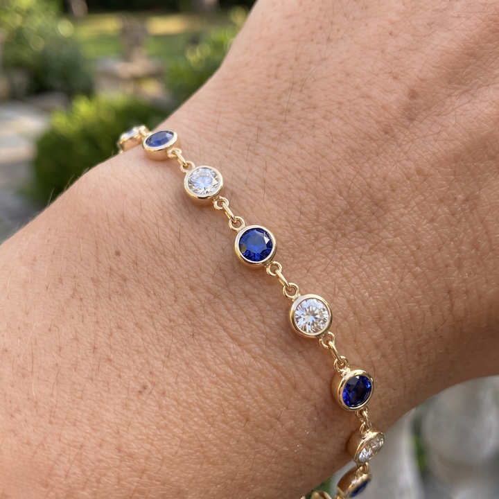 Luxury tennis bracelet with round blue gemstones and brilliant white diamonds.