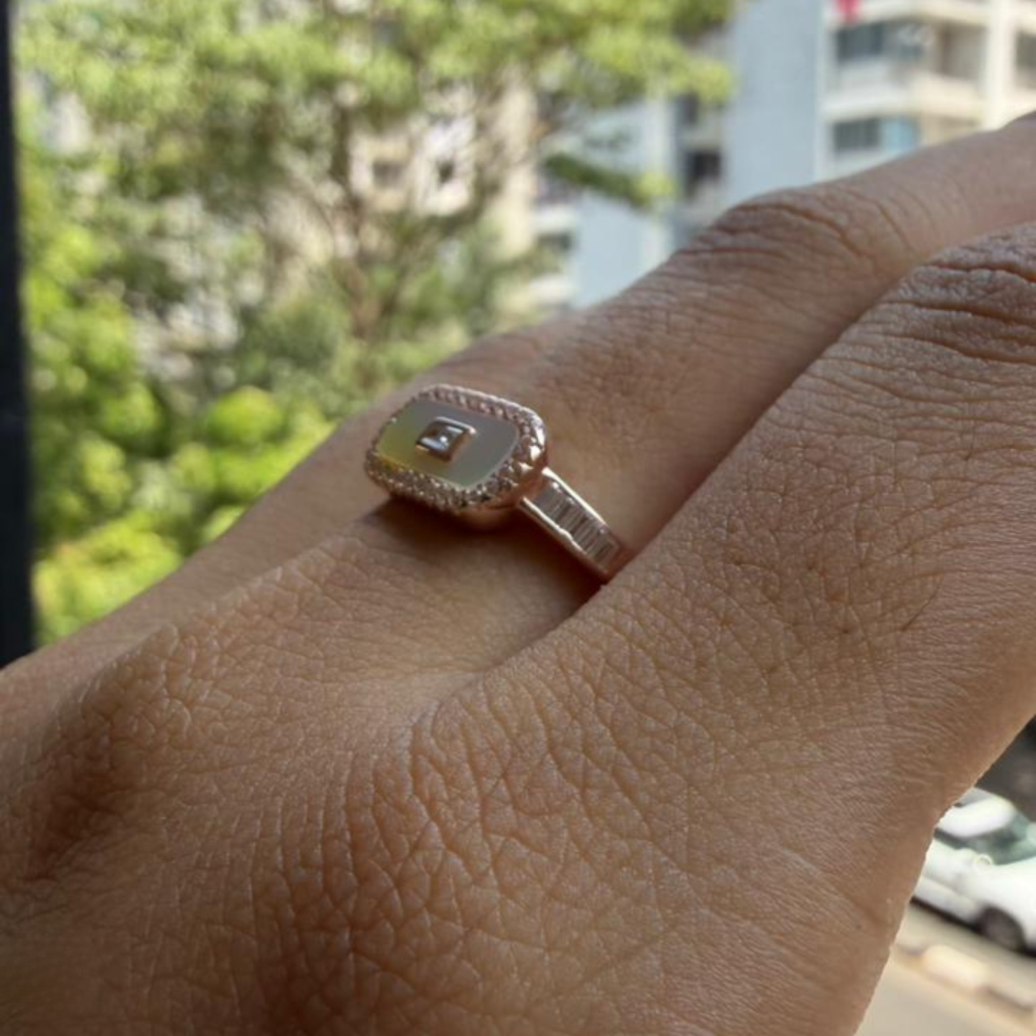 Geometric diamond ring featuring a luminous elongated mother-of-pearl center.