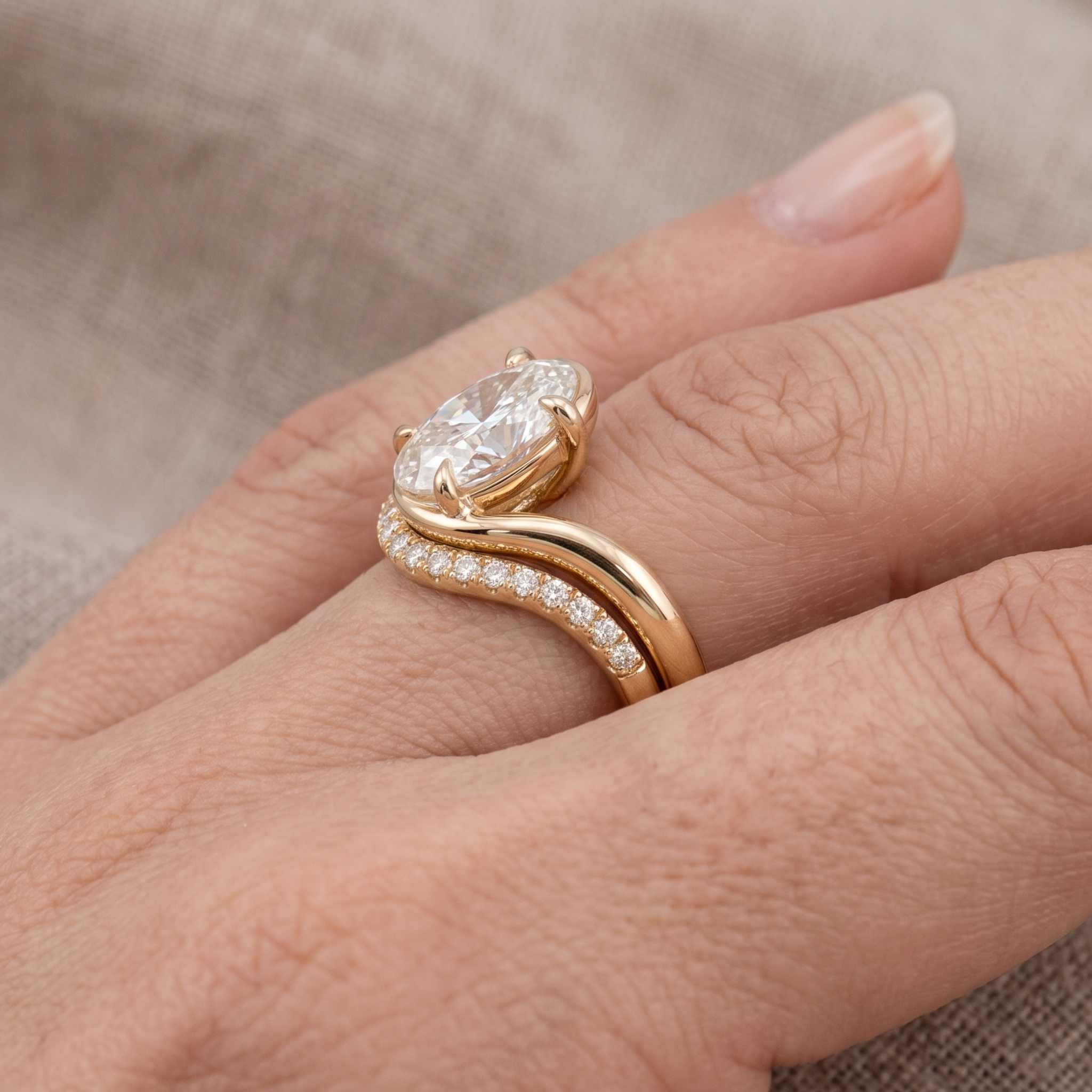 Yellow gold oval engagement ring with sculptural wave setting