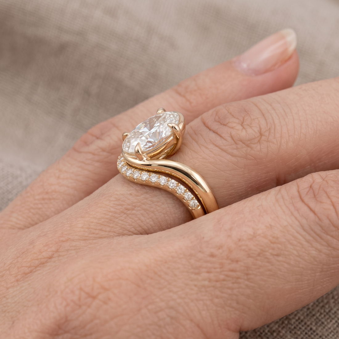 Yellow gold oval engagement ring with sculptural wave setting