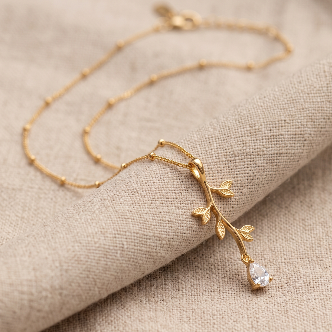Kiashaa Jewellery 0.39 CT pear diamond leaf pendant necklace in polished yellow gold.