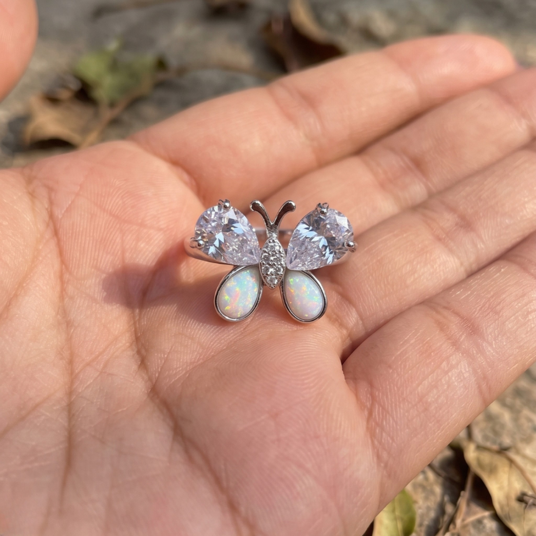 Nature-inspired butterfly ring featuring pear-shaped lab-grown diamonds and opal gemstones.