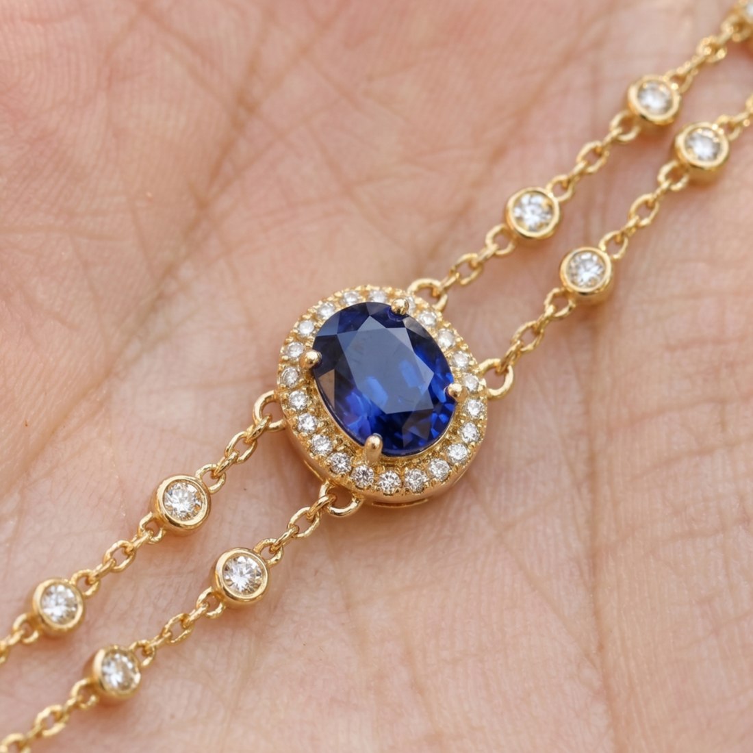 2 CT oval blue sapphire bracelet with diamond halo in yellow gold by Kiashaa Jewellery.