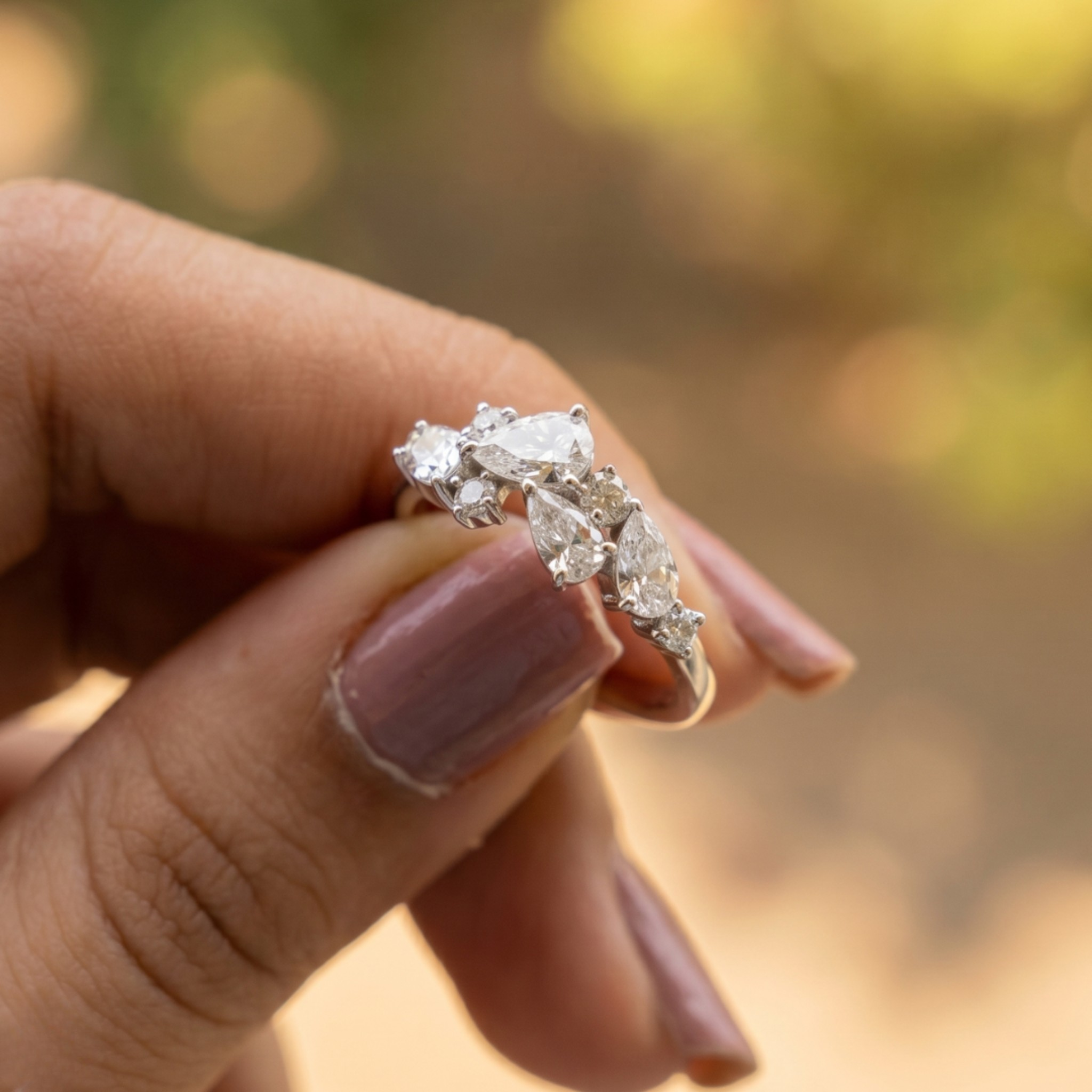 Handcrafted lab-grown diamond ring with pear and round brilliant stones.