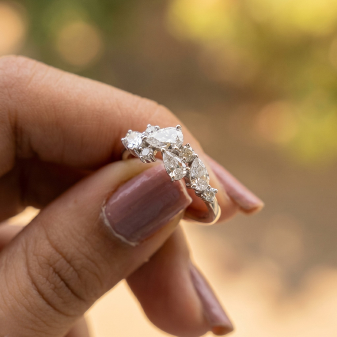 Handcrafted lab-grown diamond ring with pear and round brilliant stones.