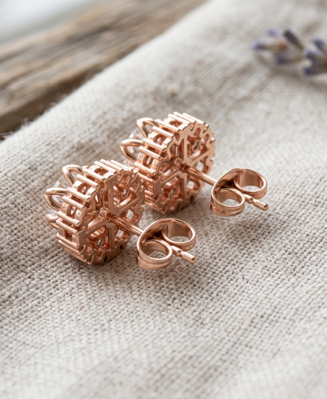 Close-up of round lab-grown diamond halo earrings with secure multi-prong setting.